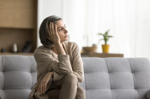 Sad,Thoughtful,Grey,Haired,Woman,Sitting,On,Sofa,At,Home, Sad,Thoughtful,Grey,Haired,Woman,Sitting,On,Sofa,At,Home,