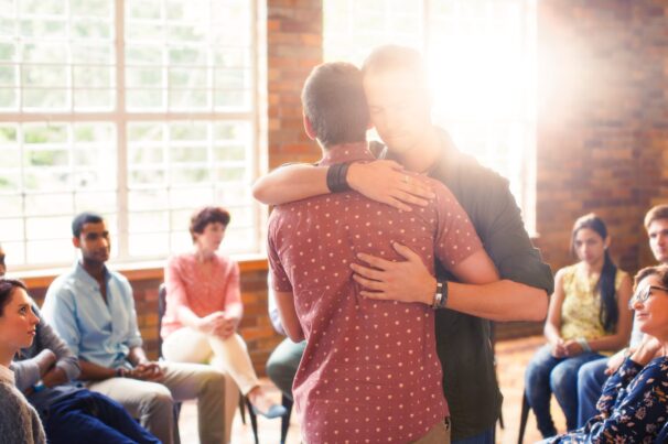 Men,Hugging,At,Group,Therapy,Session Men,Hugging,At,Group,Therapy,Session