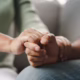 Female,Friend,Or,Family,Sitting,And,Hold,Hands,During,Cheer